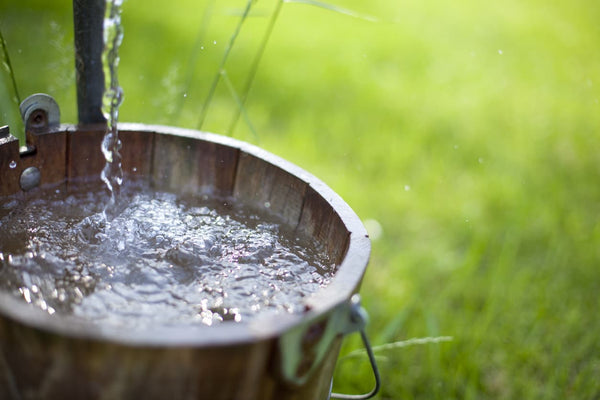 Water flowing into a bucket from a well 