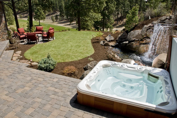 Meticulous and picturesque landscaping done around a hot tub