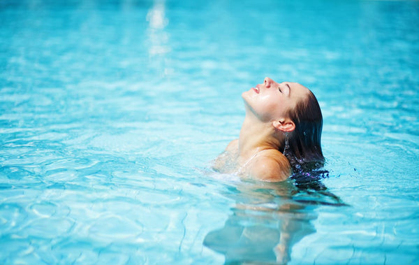 A woman enjoying the benefits of a swim spa
